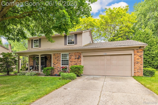 3184 Cedar Key Dr, Lake Orion, MI 48360 - traditional home with brick siding, covered porch, a front yard, an attached garage, and driveway