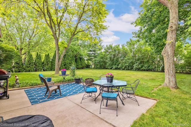 3184 Cedar Key Dr, Lake Orion, MI 48360 - view of patio featuring outdoor dining space, view of scattered trees, and a grill