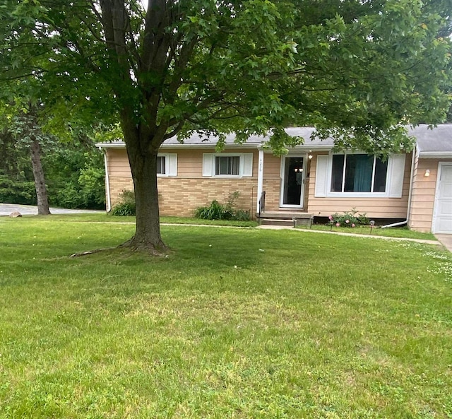 4236 Marianne Dr, Flushing, MI 48433 - view of front facade with a front yard, brick siding, and a garage