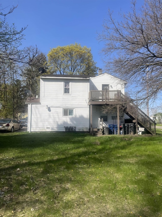 1021 2nd St, Flint, MI 48503 - rear view of house featuring stairway, a yard, a deck, and a chimney