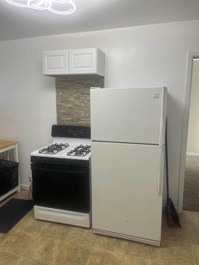 1021 2nd St, Flint, MI 48503 - kitchen featuring freestanding refrigerator, gas stove, and white cabinets