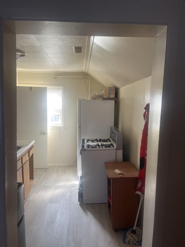 1021 2nd St, Flint, MI 48503 - kitchen featuring gas range gas stove, light wood finished floors, and lofted ceiling