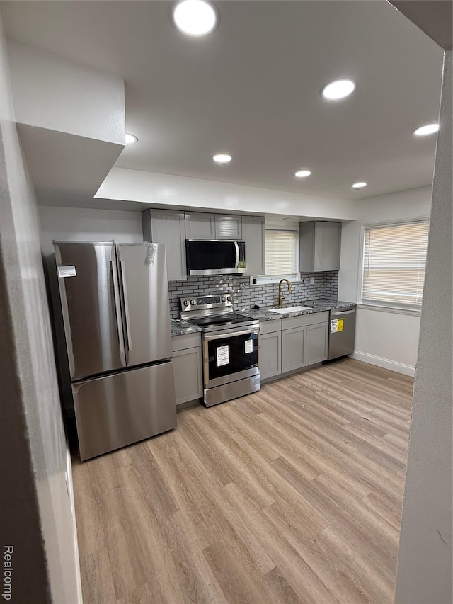 11735 Braile St, Detroit, MI 48228 - kitchen featuring appliances with stainless steel finishes, gray cabinets, tasteful backsplash, light wood-style flooring, and recessed lighting