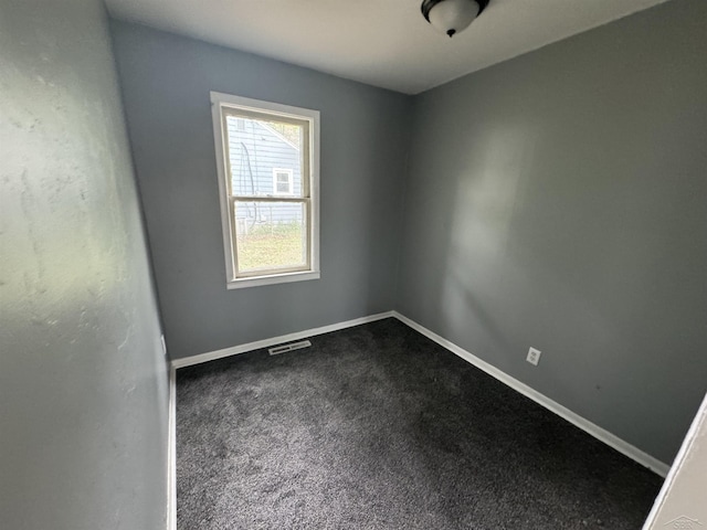 1807 Union Ave, Saginaw, MI 48602 - empty room featuring dark carpet and baseboards