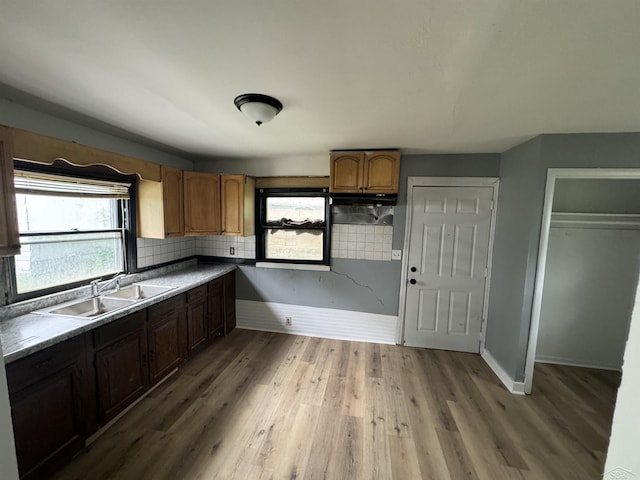 1807 Union Ave, Saginaw, MI 48602 - kitchen featuring decorative backsplash, light wood finished floors, and brown cabinets