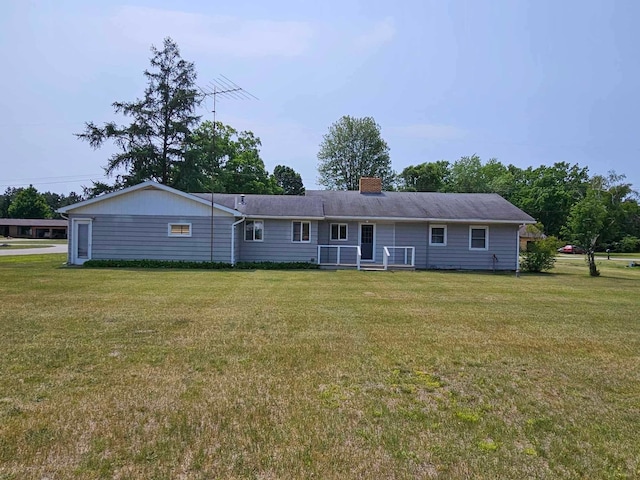 1363 Swain St, White Cloud, MI 49349 - back of house featuring a yard and a chimney