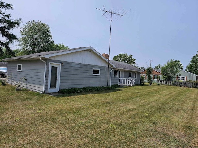 1363 Swain St, White Cloud, MI 49349 - rear view of property featuring a lawn and a chimney