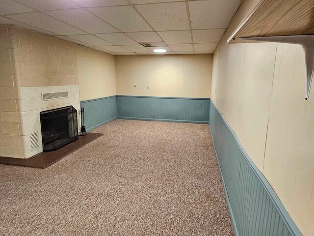1363 Swain St, White Cloud, MI 49349 - finished below grade area with carpet, a large fireplace, a wainscoted wall, and a drop ceiling