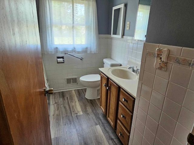 1363 Swain St, White Cloud, MI 49349 - bathroom featuring tile walls, wood finished floors, vanity, and wainscoting