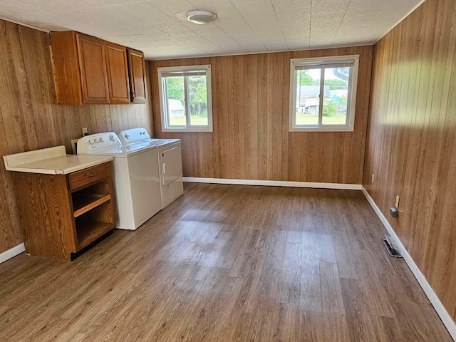 1363 Swain St, White Cloud, MI 49349 - laundry area with cabinet space, independent washer and dryer, wood finished floors, and wooden walls