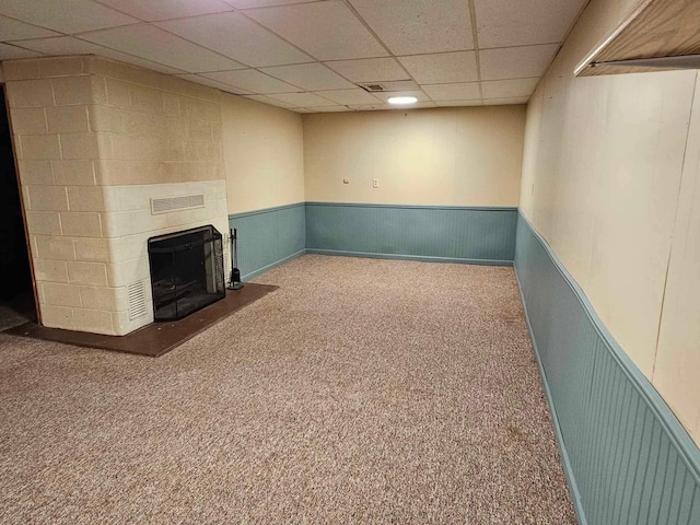 1363 Swain St, White Cloud, MI 49349 - finished below grade area featuring a drop ceiling, a wainscoted wall, carpet, and a fireplace