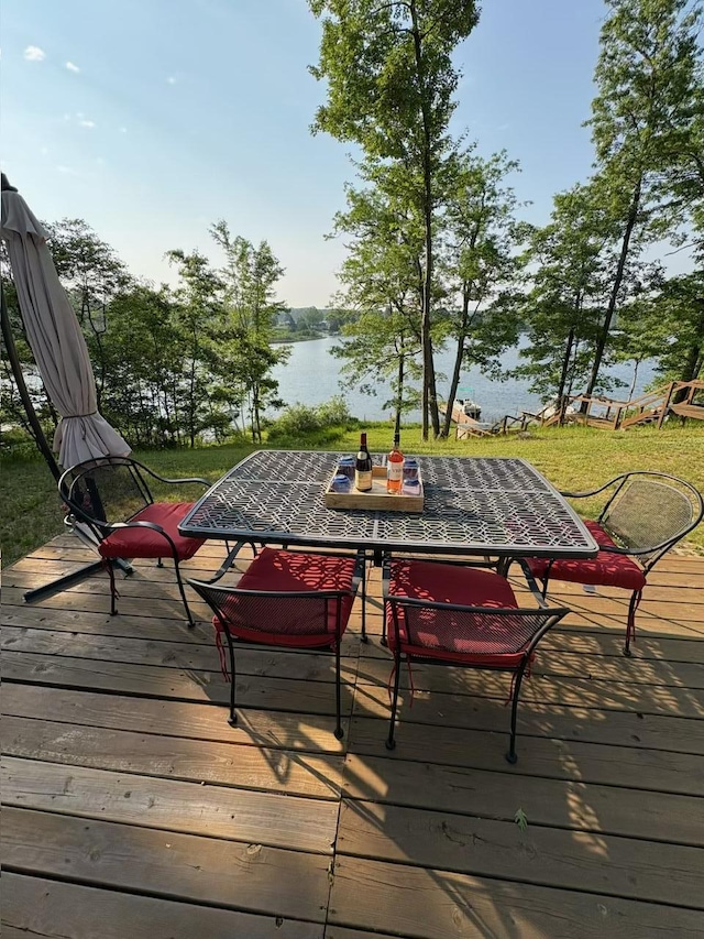 5814 N Trails End Dr, Irons, MI 49644 - wooden terrace featuring outdoor dining space and a water view