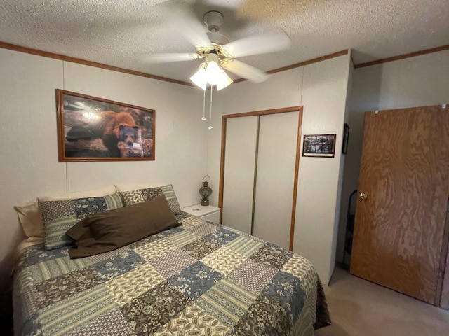 5814 N Trails End Dr, Irons, MI 49644 - bedroom with ornamental molding, a closet, a textured ceiling, carpet floors, and ceiling fan