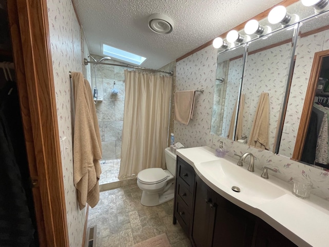 5814 N Trails End Dr, Irons, MI 49644 - bathroom with wallpapered walls, a skylight, vanity, a tile shower, and a textured ceiling