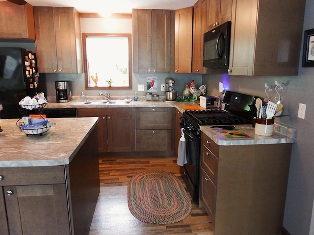 3461 S James Rd, Baldwin, MI 49304 - kitchen featuring black appliances, wood finished floors, and light countertops