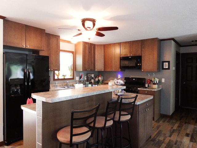 3461 S James Rd, Baldwin, MI 49304 - kitchen featuring black appliances, light countertops, and dark wood-style floors
