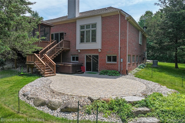 6439 Cohoctah Rd, Fenton, MI 48430 - rear view of house with a hot tub, a patio, a sunroom, a chimney, and stairway