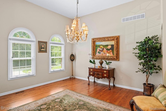 6439 Cohoctah Rd, Fenton, MI 48430 - sitting room featuring wood finished floors, a chandelier, and plenty of natural light