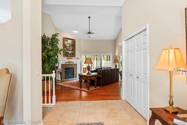 6439 Cohoctah Rd, Fenton, MI 48430 - entryway with lofted ceiling, light tile patterned floors, and a fireplace
