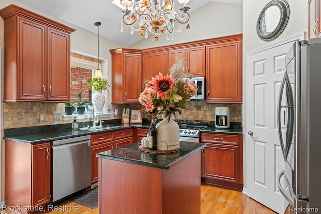 6439 Cohoctah Rd, Fenton, MI 48430 - kitchen featuring appliances with stainless steel finishes, lofted ceiling, a chandelier, pendant lighting, and backsplash