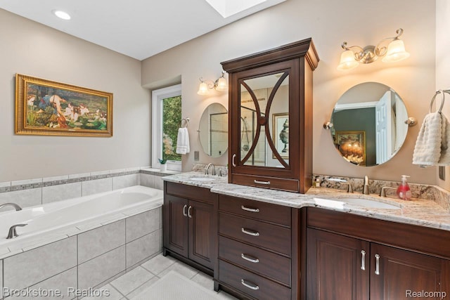 6439 Cohoctah Rd, Fenton, MI 48430 - full bath with double vanity, a garden tub, tile patterned floors, and a skylight