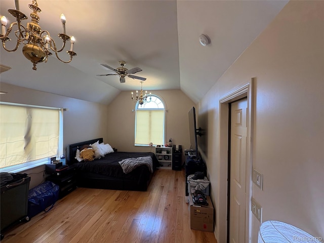 3351 Reid Rd, Swartz Creek, MI 48473 - bedroom featuring a chandelier, vaulted ceiling, light wood-type flooring, and a ceiling fan