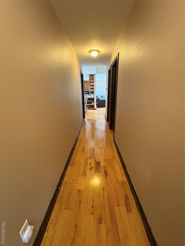 3351 Reid Rd, Swartz Creek, MI 48473 - hallway featuring light wood-style floors and baseboards