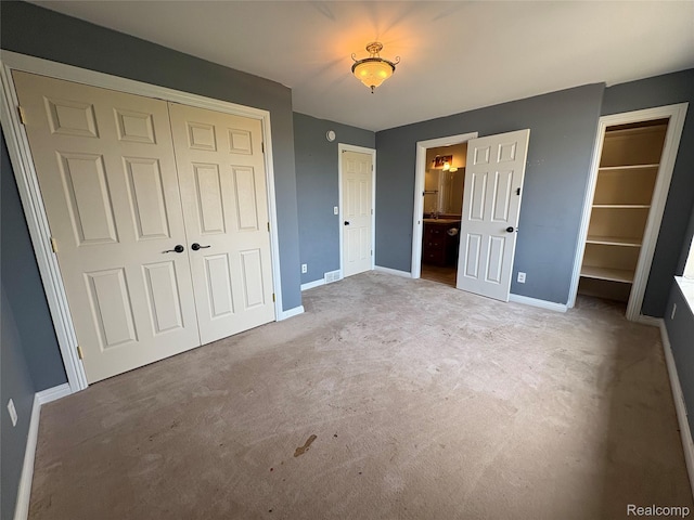 3351 Reid Rd, Swartz Creek, MI 48473 - unfurnished bedroom featuring carpet, a closet, and ensuite bathroom