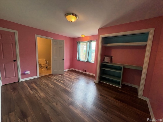 3351 Reid Rd, Swartz Creek, MI 48473 - unfurnished bedroom featuring dark wood-type flooring and baseboards
