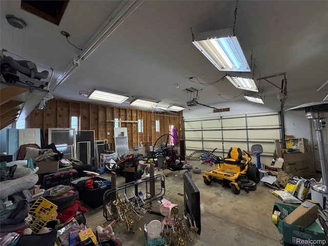 3351 Reid Rd, Swartz Creek, MI 48473 - garage featuring a garage door opener and wooden walls