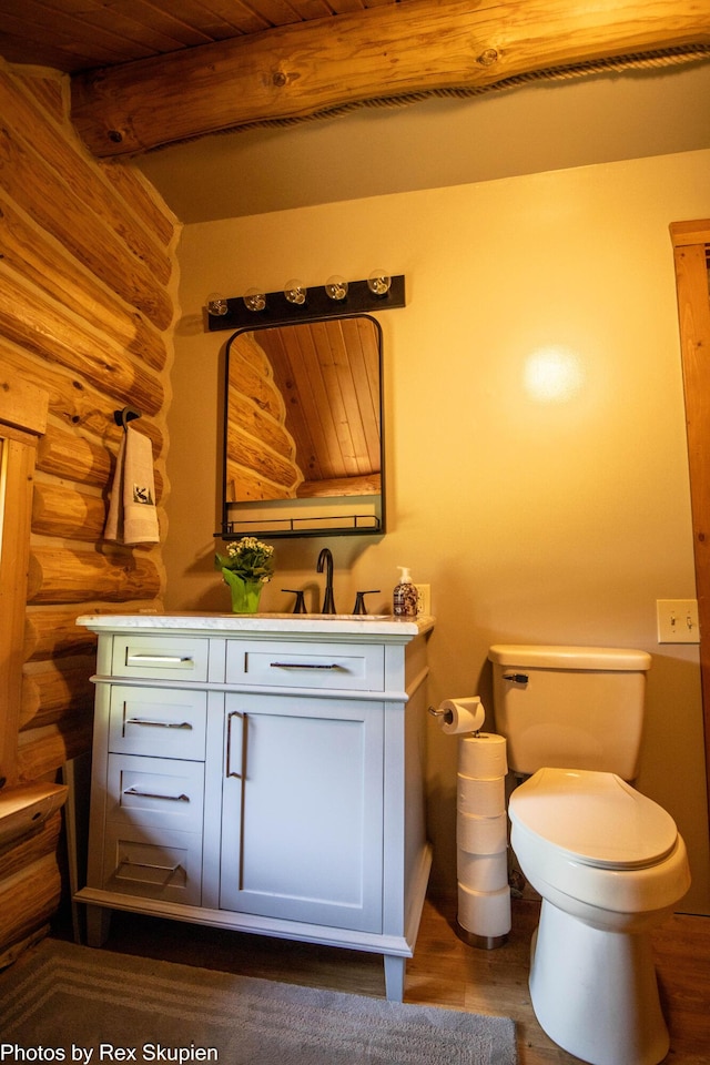 4585 W Arrowhead Dr, White Cloud, MI 49349 - half bath featuring rustic walls, vanity, wood finished floors, and a wooden ceiling with exposed beams