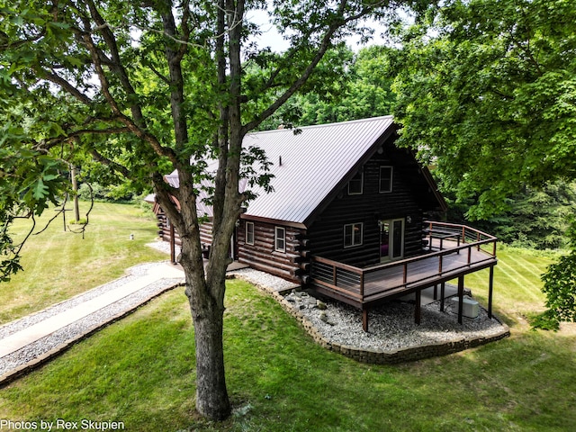 4585 W Arrowhead Dr, White Cloud, MI 49349 - rear view of house featuring log exterior, a wooden deck, a yard, and a metal roof