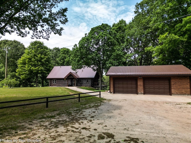 4585 W Arrowhead Dr, White Cloud, MI 49349 - view of front facade with a garage, a metal roof, and an outdoor structure