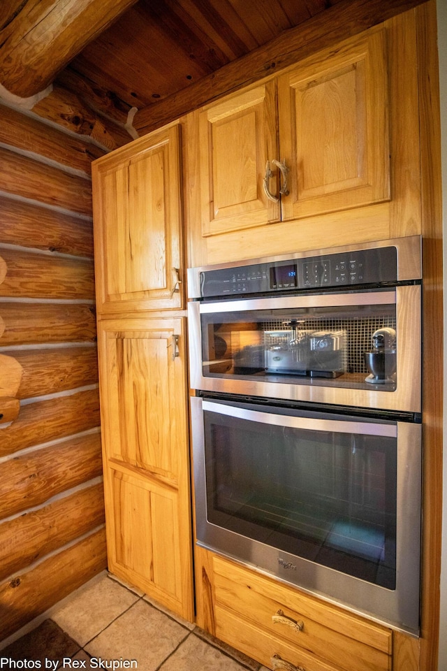 4585 W Arrowhead Dr, White Cloud, MI 49349 - kitchen view of stainless steel double oven, rustic walls, and wooden ceiling