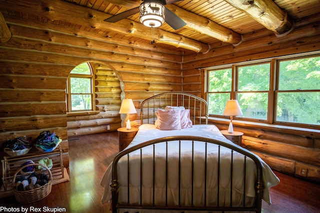 4585 W Arrowhead Dr, White Cloud, MI 49349 - bedroom with a wooden ceiling with exposed beams, hardwood / wood-style flooring, multiple windows, and rustic walls