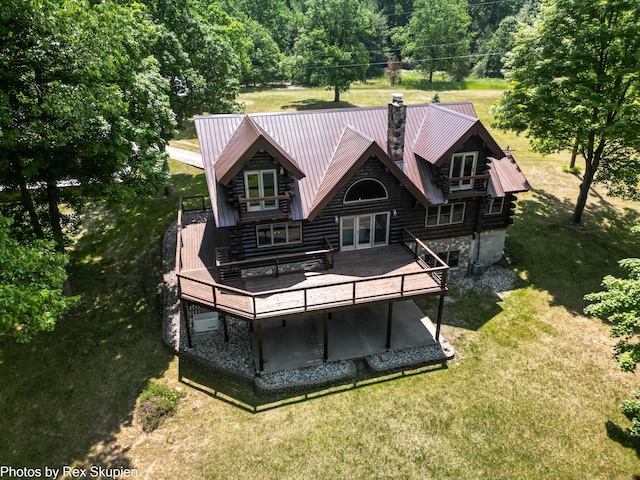 4585 W Arrowhead Dr, White Cloud, MI 49349 - rear view of house featuring log exterior, a yard, a chimney, and a deck