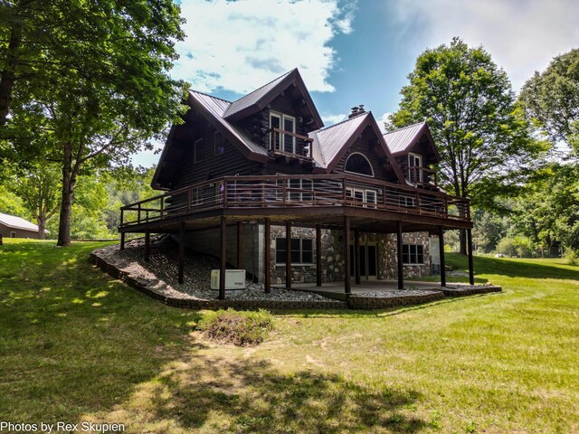4585 W Arrowhead Dr, White Cloud, MI 49349 - rear view of house with a wooden deck, a yard, a patio, stone siding, and log exterior