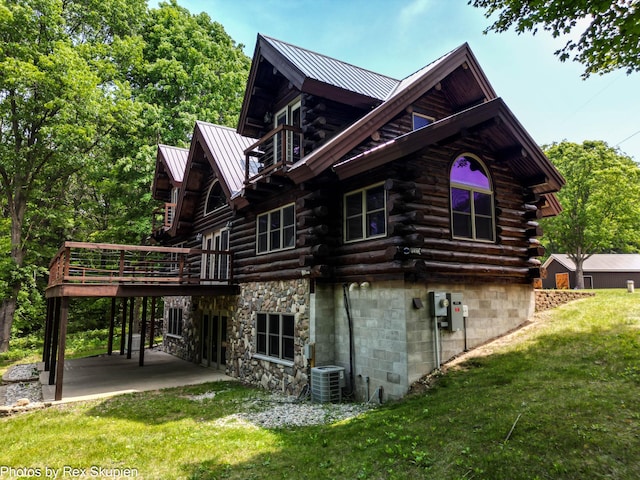 4585 W Arrowhead Dr, White Cloud, MI 49349 - view of property exterior with log exterior, a yard, a patio area, a metal roof, and a deck