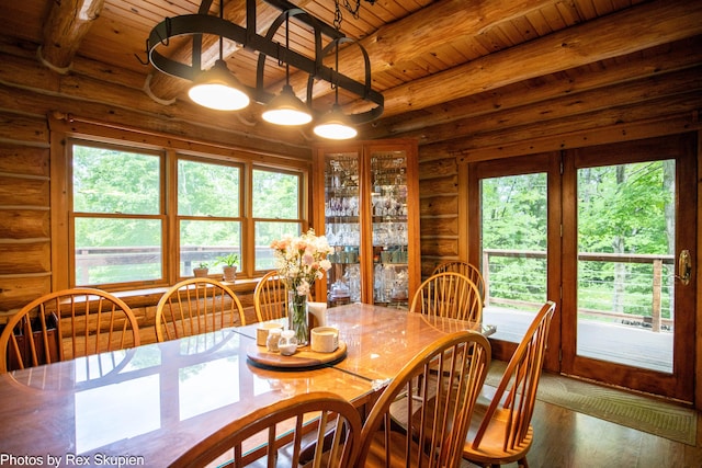 4585 W Arrowhead Dr, White Cloud, MI 49349 - dining area featuring a wood ceiling with exposed beams, wood finished floors, and rustic walls