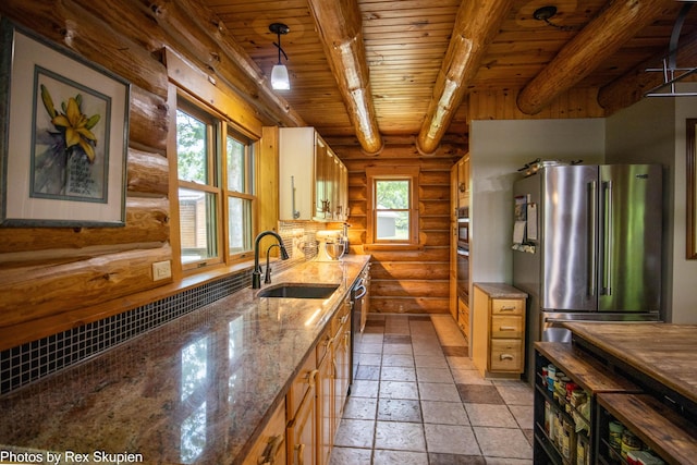 4585 W Arrowhead Dr, White Cloud, MI 49349 - kitchen featuring freestanding refrigerator, a wood ceiling with exposed beams, log walls, stone tile flooring, and stone counters