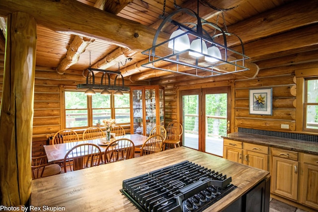 4585 W Arrowhead Dr, White Cloud, MI 49349 - kitchen with black gas cooktop, a wooden ceiling with exposed beams, rustic walls, wooden counters, and a chandelier