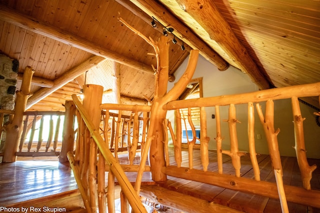 4585 W Arrowhead Dr, White Cloud, MI 49349 - staircase featuring a wood ceiling with exposed beams, rustic walls, hardwood / wood-style floors, and high vaulted ceiling