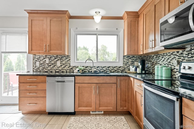 438 Oakgrove Ct, Clawson, MI 48017 - kitchen with stainless steel appliances, tasteful backsplash, and dark stone countertops