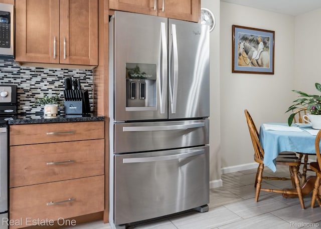 438 Oakgrove Ct, Clawson, MI 48017 - kitchen featuring appliances with stainless steel finishes, decorative backsplash, brown cabinetry, and dark stone countertops