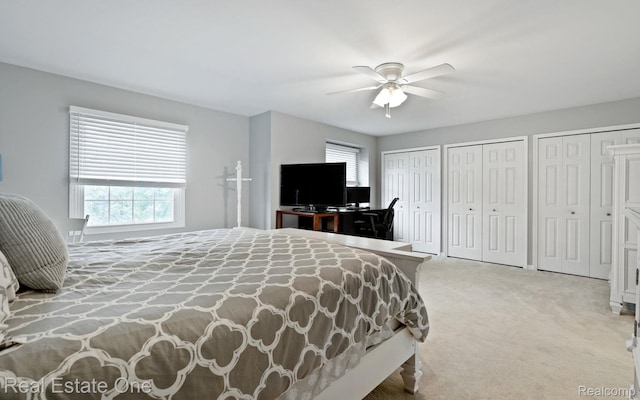 438 Oakgrove Ct, Clawson, MI 48017 - carpeted bedroom featuring multiple closets, multiple windows, and a ceiling fan
