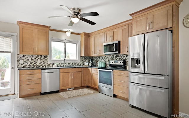 438 Oakgrove Ct, Clawson, MI 48017 - kitchen featuring stainless steel appliances, dark countertops, ceiling fan, and tasteful backsplash