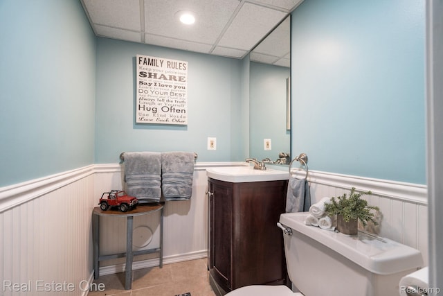 438 Oakgrove Ct, Clawson, MI 48017 - bathroom featuring a wainscoted wall, vanity, tile patterned floors, and a paneled ceiling