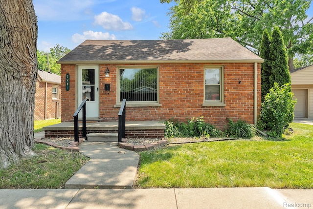 5941 Ziegler St, Taylor, MI 48180 - view of front facade with roof with shingles, brick siding, a front lawn, and a garage