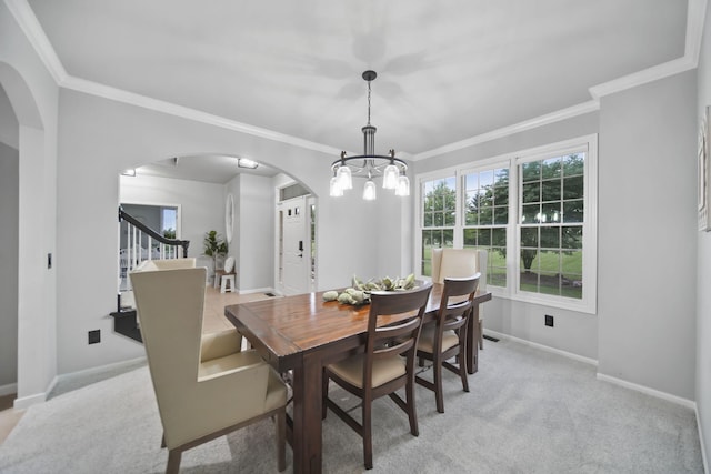 874 Pinecrest, Dexter, MI 48130 - dining room with arched walkways, ornamental molding, a chandelier, light carpet, and stairs