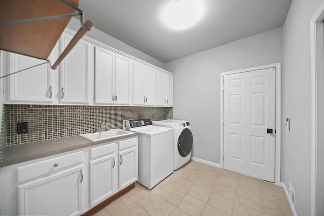 874 Pinecrest, Dexter, MI 48130 - laundry area featuring cabinet space, washer and dryer, and light tile patterned floors